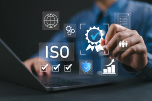 ISO certification and quality management concept. Businessman reviewing ISO certification standards with digital icons representing quality control, management, and compliance processes.